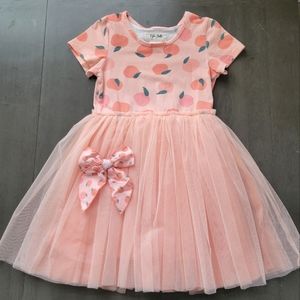 Taylor Joelle Peach print tutu dress with matching bow.